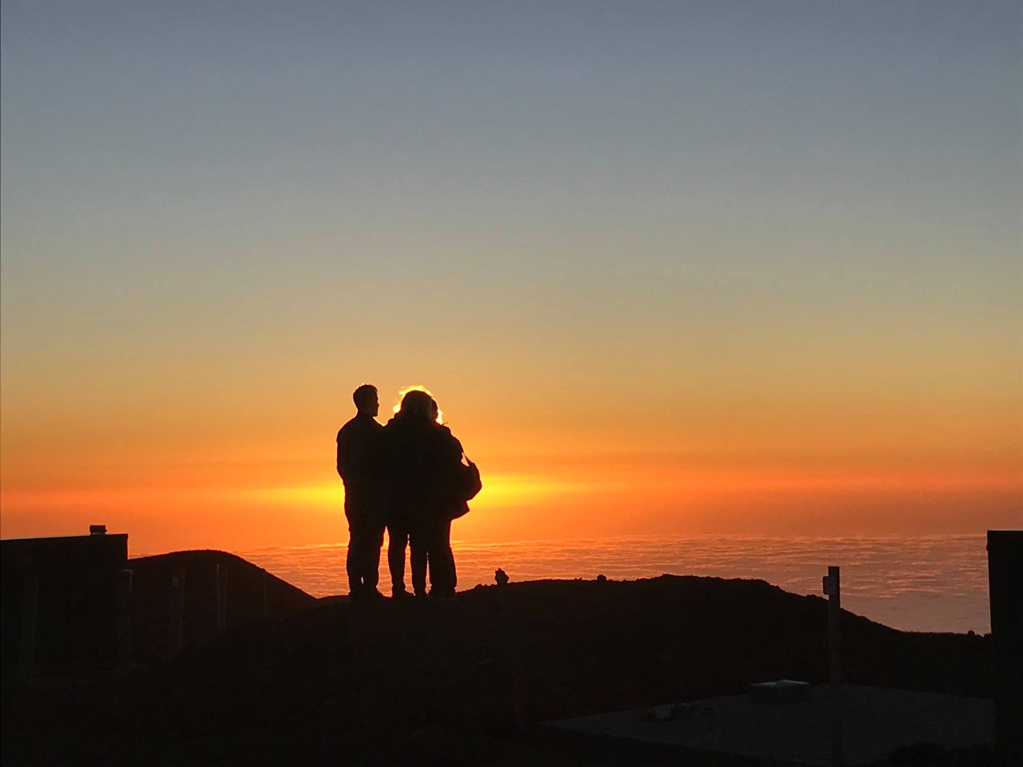 Visitor looking at a Mauna Kea summit sunset